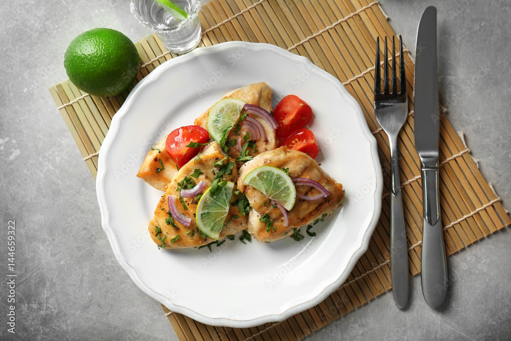Plate of delicious tequila lime chicken on light background Plate of delicious tequila lime chicken on light background