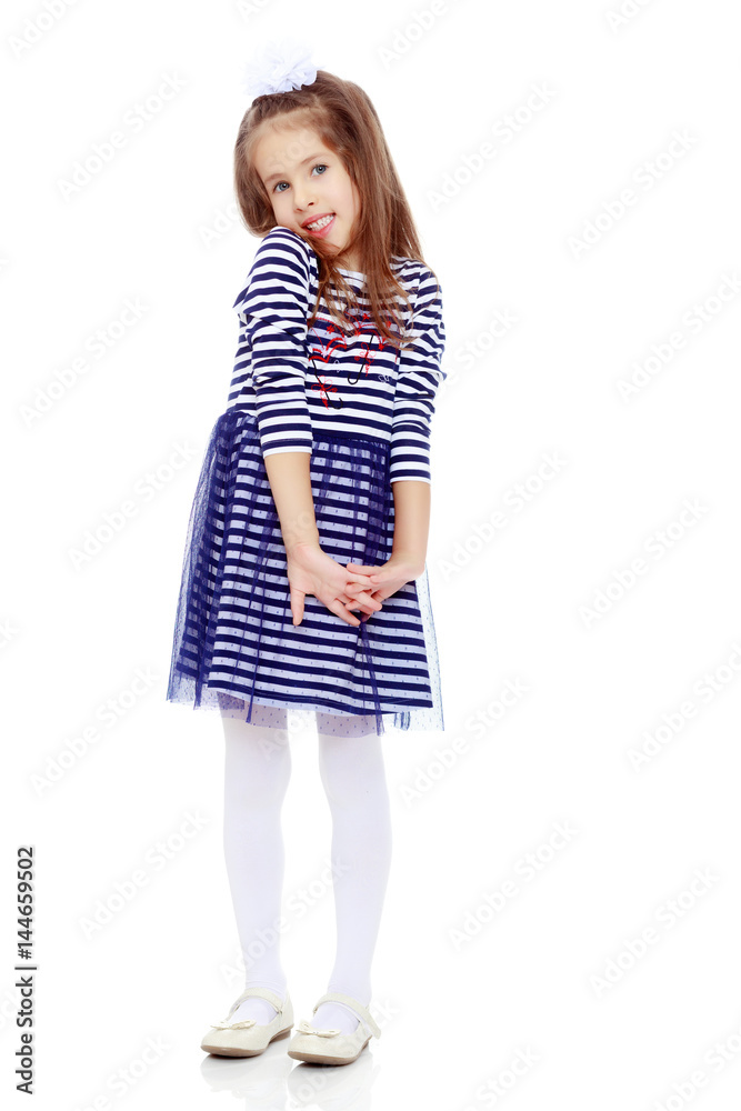 Cute little girl posing in front of the camera. Cute little girl posing in front of the camera.