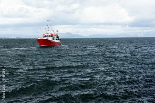 Red fishing boat in the Irish Sea. photo