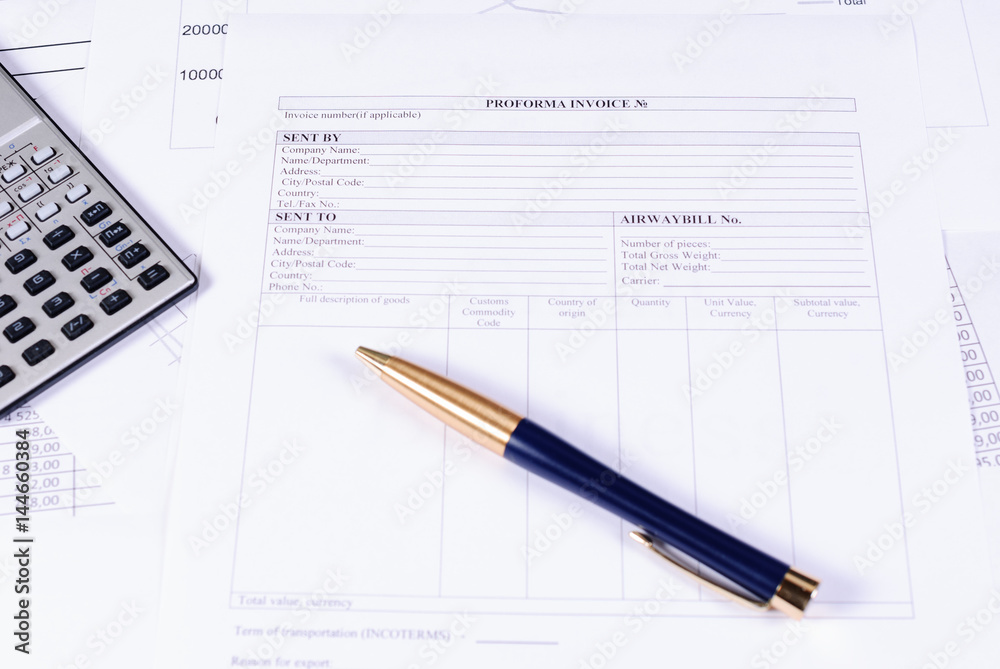 Invoice, calculator and pen on the table Invoice, calculator and pen on the table