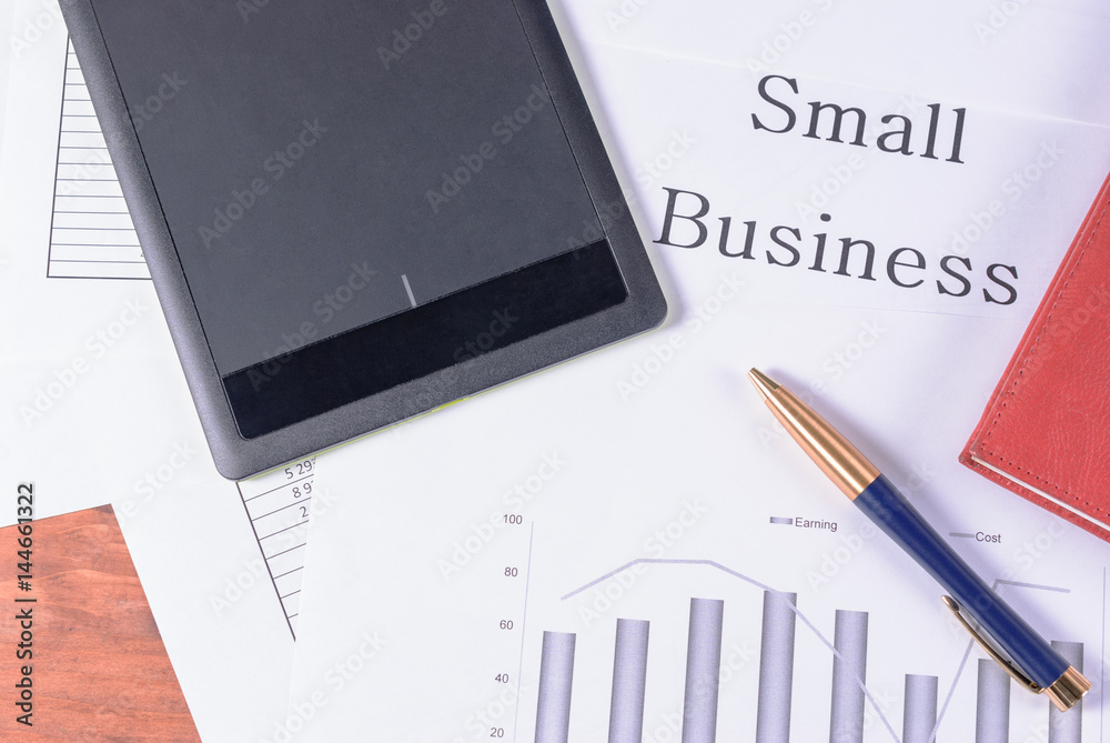 Small business. Pen, red notebook and black tablet Small business. Pen, red notebook and black tablet