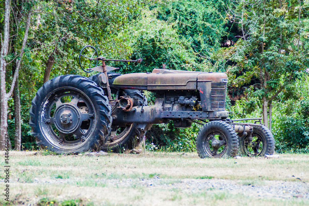 FRUTILLAR, CHILE - MARCH 1, 2015: Old tractor in Historic German Colonial Museum in Frutillar village. The region is known for a strong population of german immigrants. FRUTILLAR, CHILE - MARCH 1, 2015: Old tractor in Historic German Colonial Museum in Frutillar village. The region is known for a strong population of german immigrants.