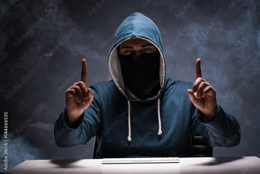 Computer hacker working in dark room Computer hacker working in dark room