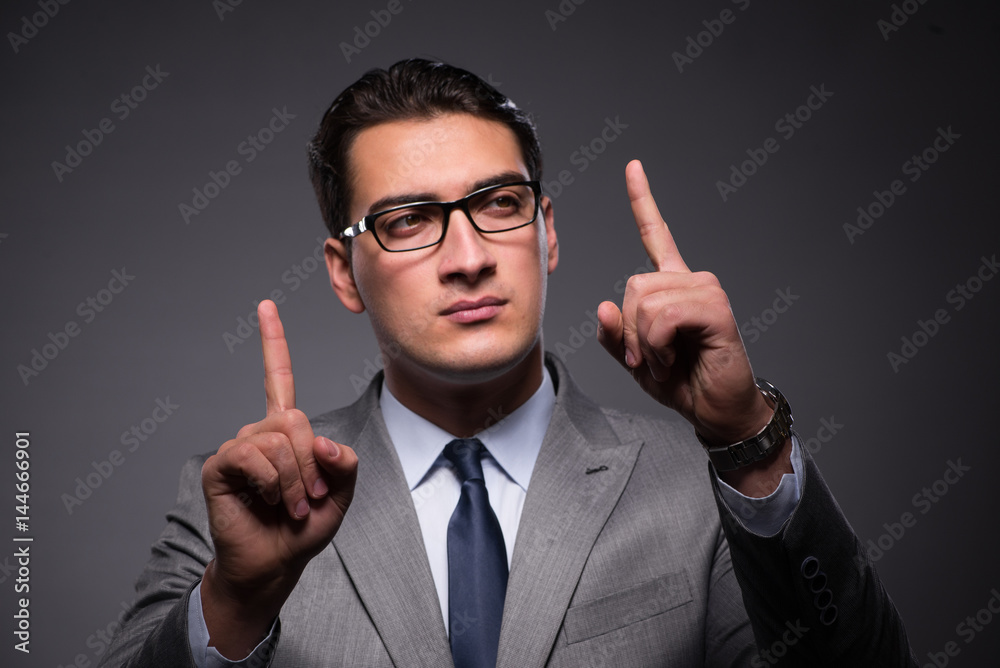 Handsome businessman pressing virtual buttons Handsome businessman pressing virtual buttons