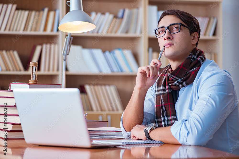 Young book writer writing in library Young book writer writing in library