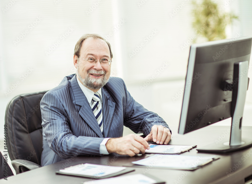 successful businessman working with financial charts at the workplace in the office successful businessman working with financial charts at the workplace in the office