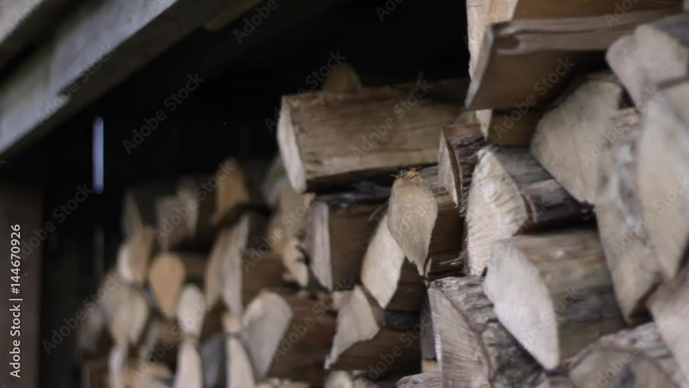 Multipurpose clip - man removes logs from woodshed and then places logs in woodshed