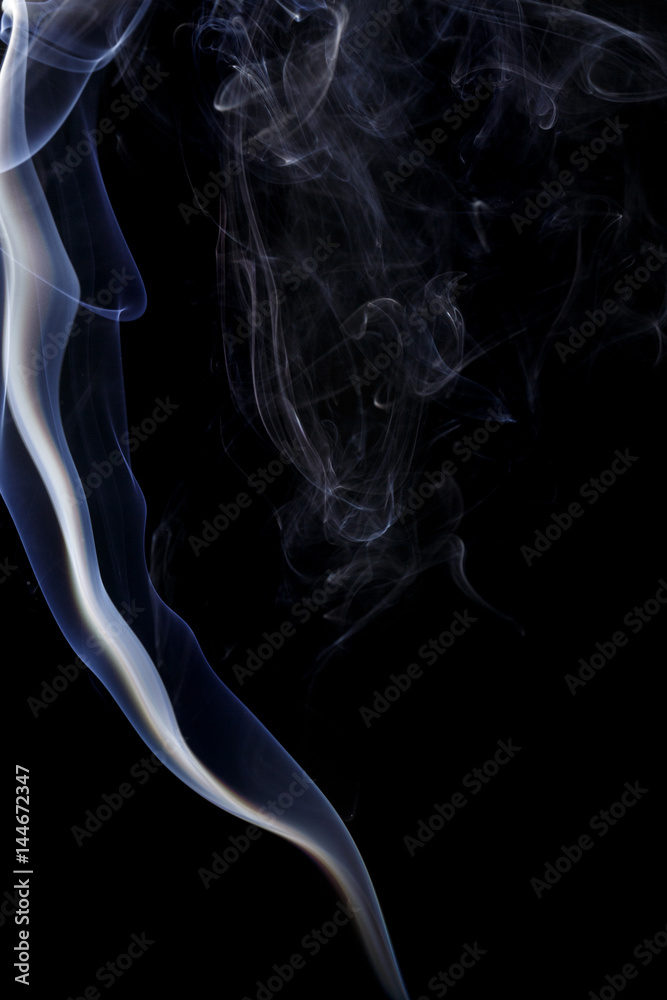 Abstract art. Color white blue smoke from the aromatic sticks on a black background. Background for Halloween. Texture fog. Design element. The concept of aromatherapy. Abstract art. Color white blue smoke from the aromatic sticks on a black background. Background for Halloween. Texture fog. Design element. The concept of aromatherapy.