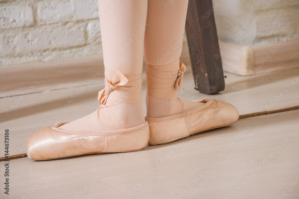 Ballerina legs first position in pointe, ballet dancer concept background.  Classic ballet positions.a pair of ballerina's feet on an wood floor. satin  ballet shoes Stock Photo | Adobe Stock