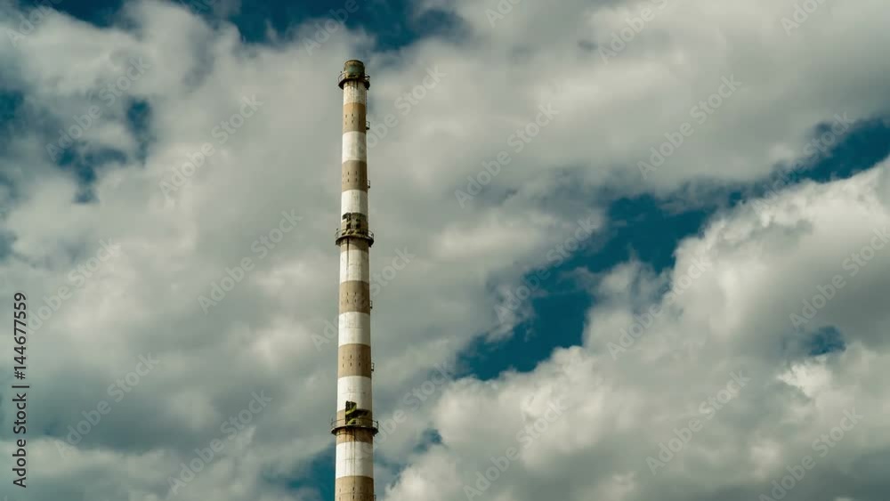 Tall decommissioned factory funnel in sky and clouds timelapse Tall decommissioned factory funnel in sky and clouds timelapse