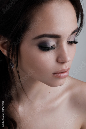Close-up portrait of brunette with evening makeup with your eyes closed