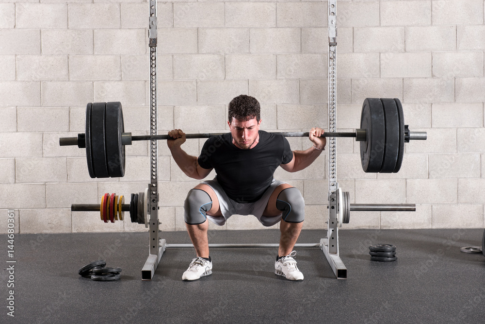 Man doing a crossfit back squat exercise Man doing a crossfit back squat exercise