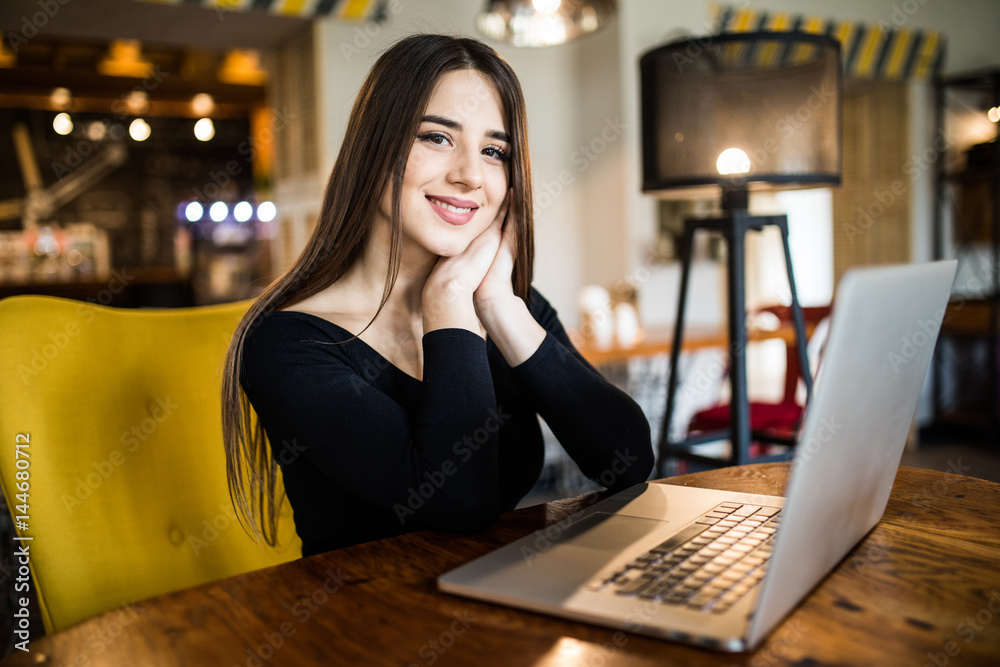 Beautiful attractive woman at the cafe with a laptop having a coffee break Beautiful attractive woman at the cafe with a laptop having a coffee break