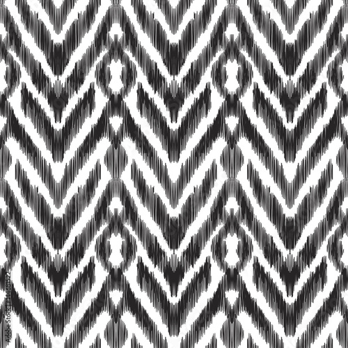 Vector illustration of the black and white colored ikat ornamental seamless pattern. Herringbone design.