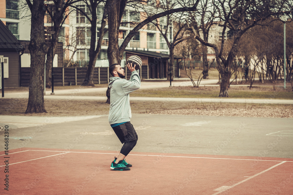African-american streetball player practicing outdoors African-american streetball player practicing outdoors