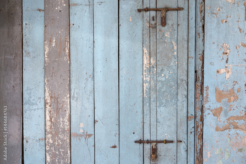 Old and faded light blue wood board wall or door texture background. Old and faded light blue wood board wall or door texture background.