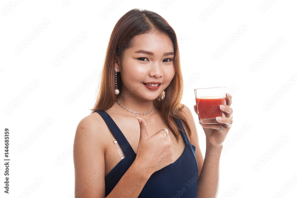 Young Asian woman thumbs up with tomato juice. Young Asian woman thumbs up with tomato juice.