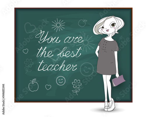 Happy Teacher's Day. The best teacher. A young fashionable woman stands near the school board with a congratulatory inscription and drawings of students for her as a gift 