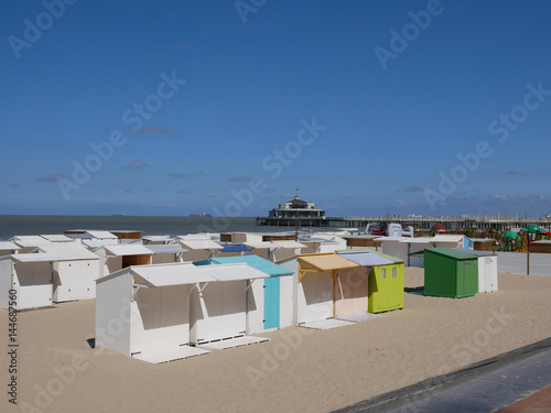 White cabanas or beach huts on a sandy beach