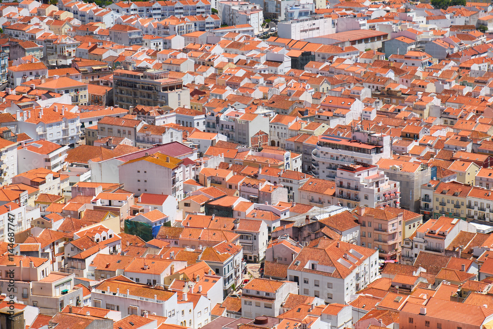 Bird's-eye view on buildings red tiled roofs of Nazare town. Portugal