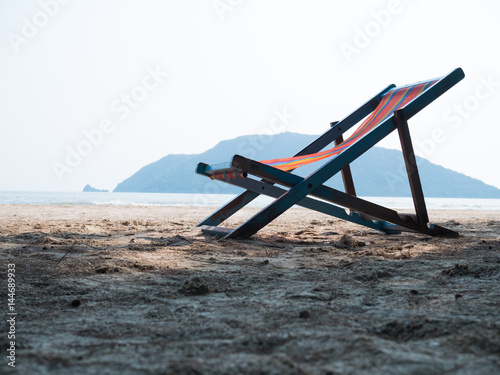 Chaise lounge on sandy beach