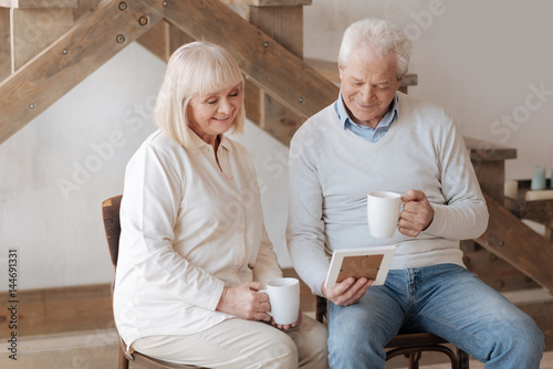 Cheerful elderly couple looking at the photo