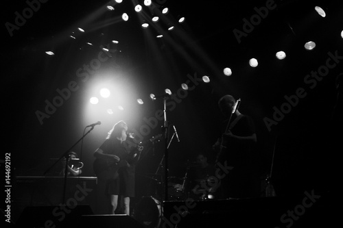 Spotlights over band on stage black and white