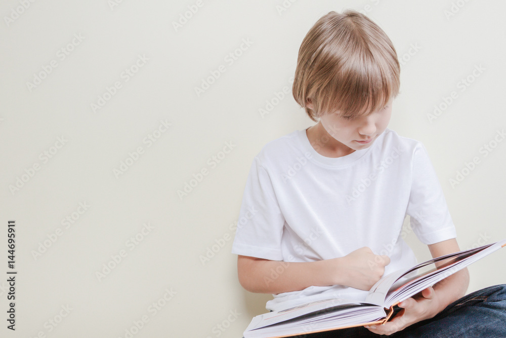 Little kid reading a book. Education, school, leisure concept Little kid reading a book. Education, school, leisure concept