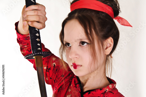 A girl handling a long samurai sword photo