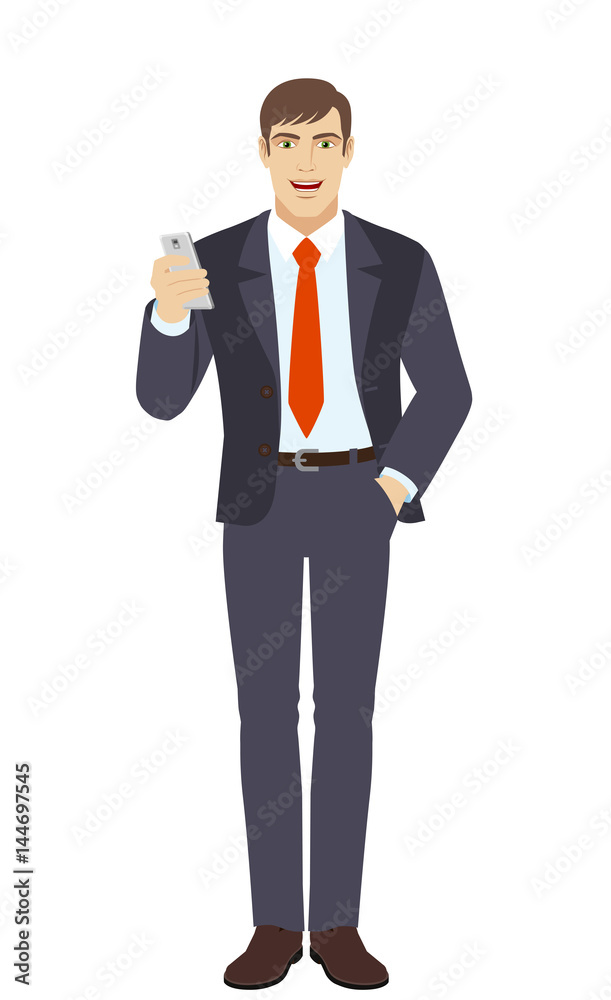Businessman with mobile phone standing with hand in pocket Businessman with mobile phone standing with hand in pocket
