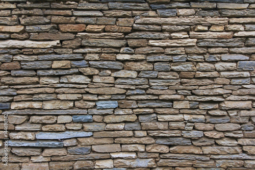 Natural grunge brown stone wall background and texture.