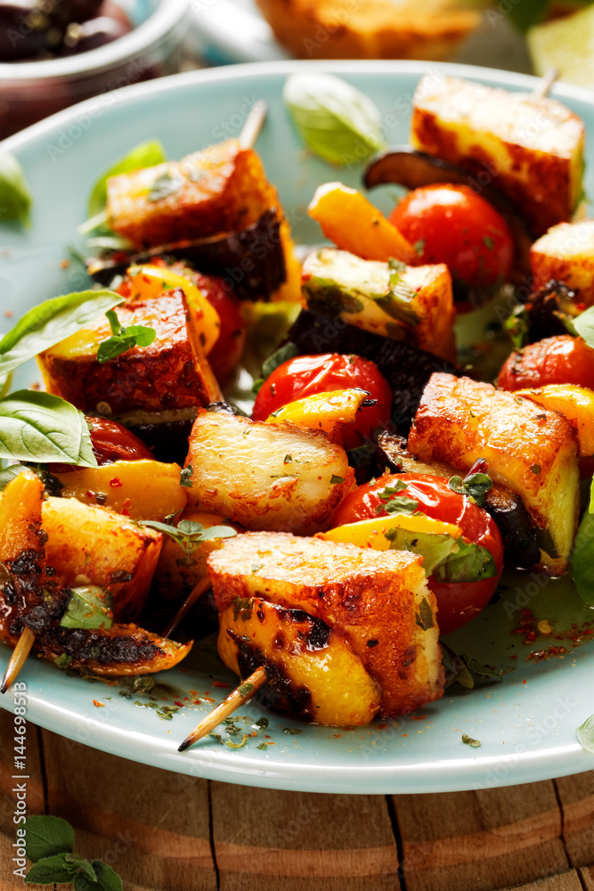 Vegetarian skewers with halloumi cheese and vegetables with addition aromatic herbs