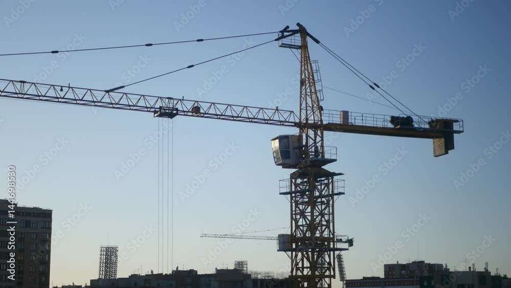 Construction crane in the blue sky and sunset in the sun. 4K Construction crane in the blue sky and sunset in the sun. 4K