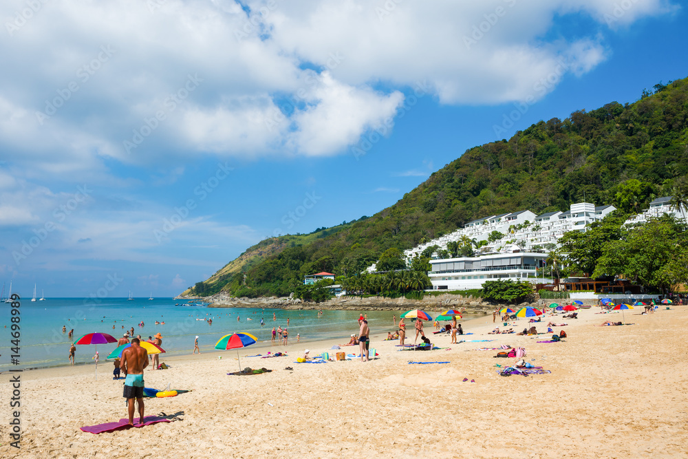 Fototapeta premium Tourists on the Nai Harn beach - one of the best beaches in Phuket, Thailand 
