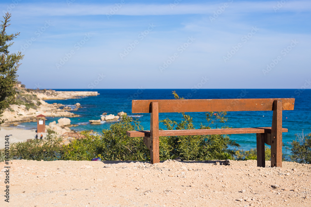 Wooden bench in front of the sea