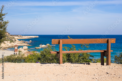 Wooden bench in front of the sea © satura_