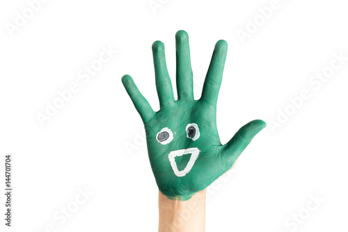 Close up of painted green child hand with funny smiley, on isolated white background.