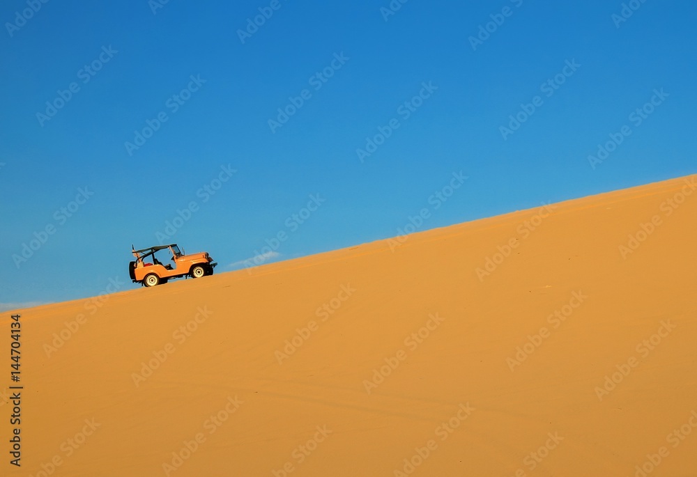 Four wheel drive vehicle in the sand dunes of muine Vietnam.