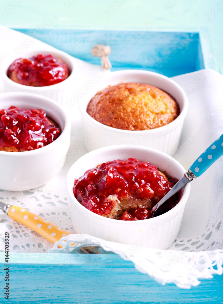 Coconut and raspberry puddings in ramekins Coconut and raspberry puddings in ramekins