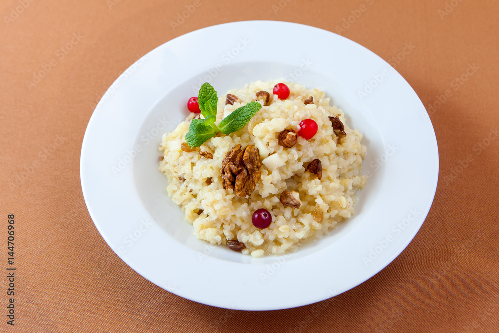 Oatmeal porridge with nuts and berries for healthy breakfast