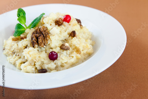 Oatmeal porridge with nuts and berries for healthy breakfast