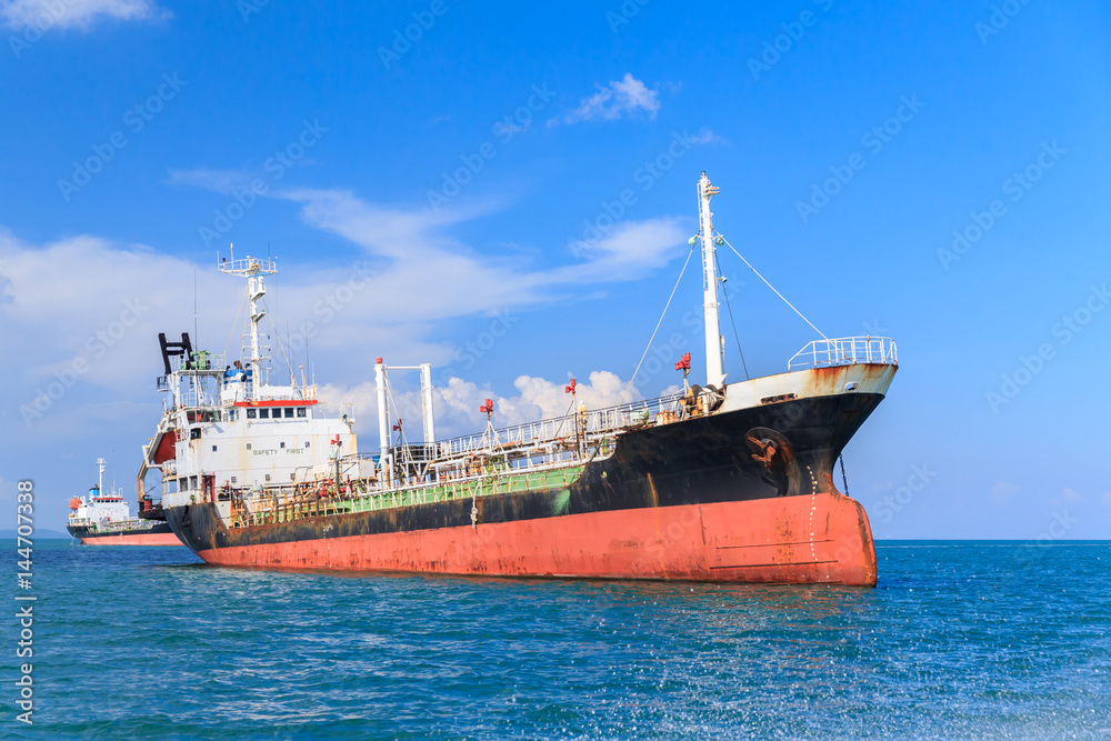 Oil tanker ship at sea on blue sky background