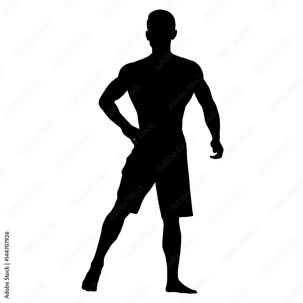 Bodybuilder standing in shorts. Hand on his hip. Bodybuilder standing in shorts. Hand on his hip.