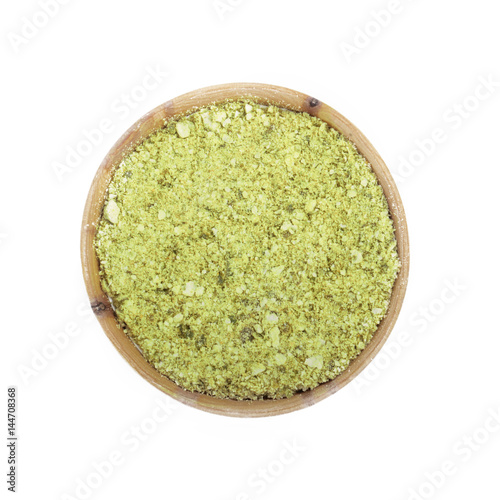 ground dried rind of lime in wooden cup isolated