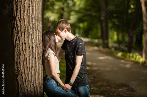 Young couple taking a walk in the park. Lifestyle and relationship. Young inlove boyfriend and girlfriend