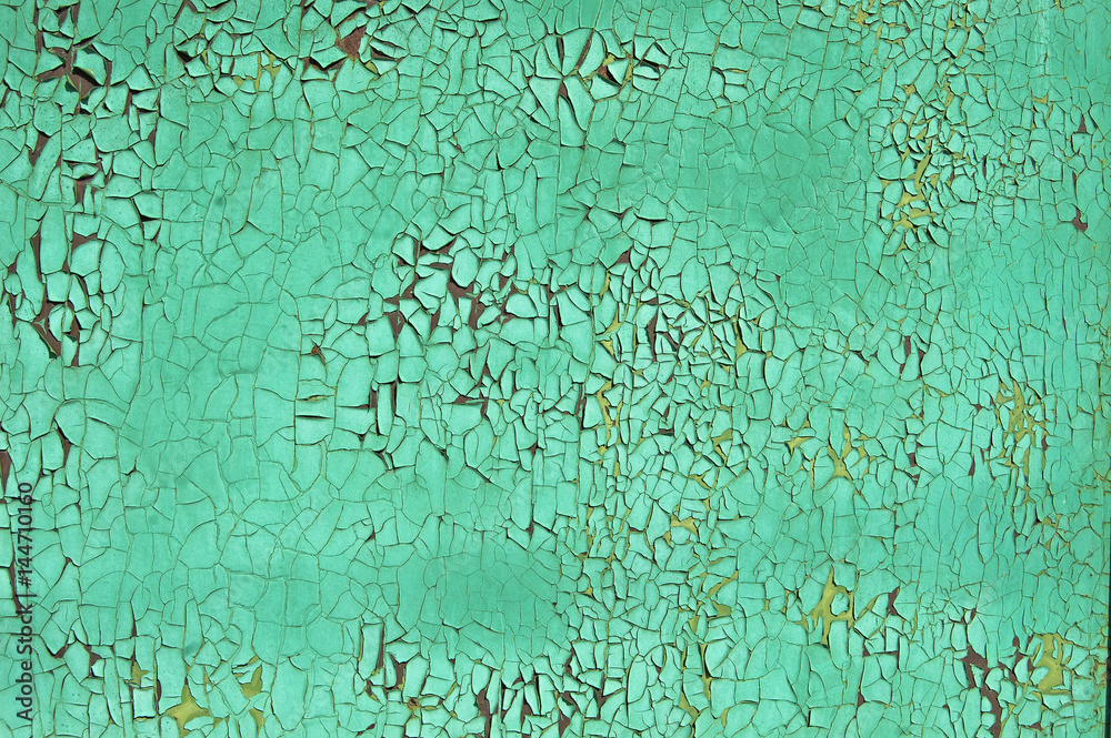 Old cracked paint pattern on rusty background. Peeling green grunge material. Damaged metal surface. Scratched plate