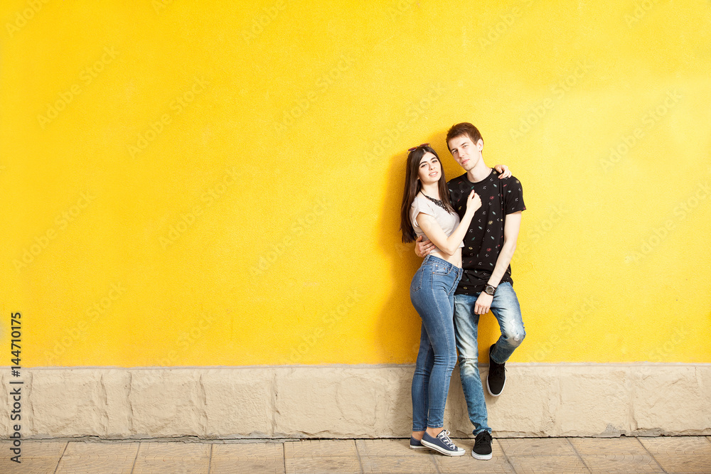 Inlove couple posing in fashion style on yellow wall. Lifestyle and relationship Inlove couple posing in fashion style on yellow wall. Lifestyle and relationship