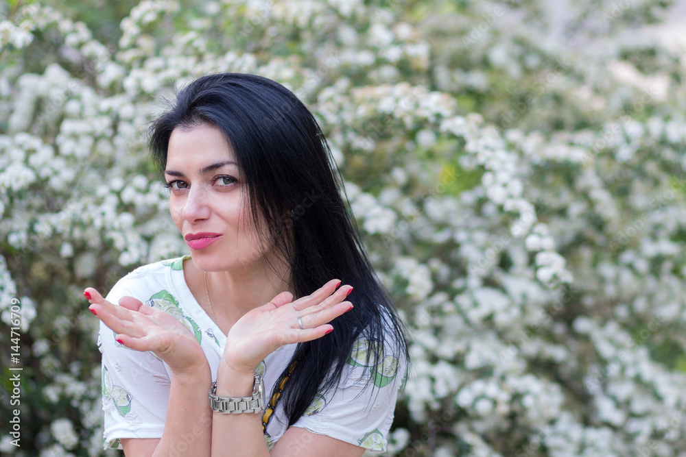 Beautiful woman in the flowered garden. People Beautiful woman in the flowered garden. People