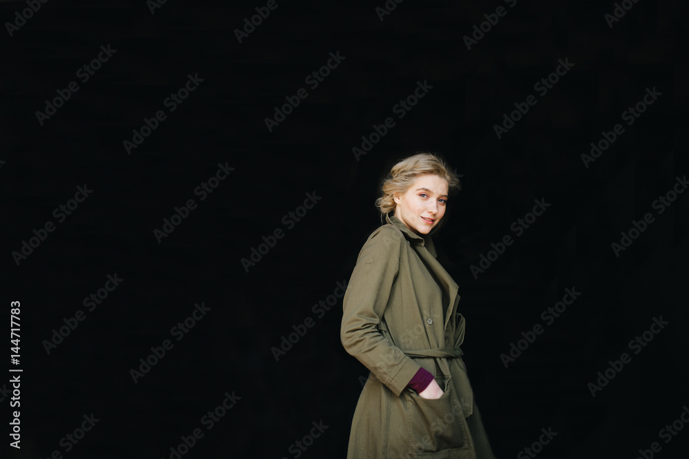 Portrait of lonely beautiful, cute, attractive, young, model blonde fashion student girl in green coat and curly hair posing at camera. Isolated on black. Tenderness and femininity. Pure beuaty. Angel Portrait of lonely beautiful, cute, attractive, young, model blonde fashion student girl in green coat and curly hair posing at camera. Isolated on black. Tenderness and femininity. Pure beuaty. Angel