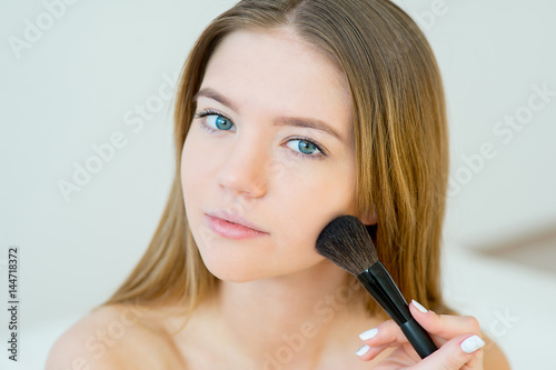 Woman applying makeup